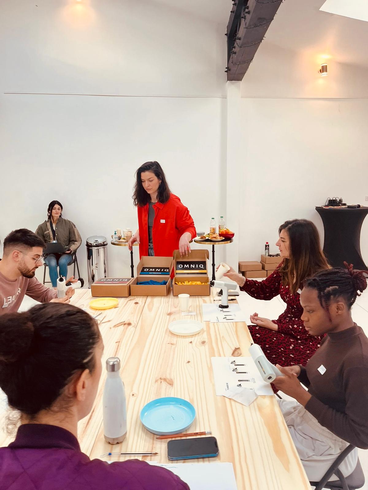 Sunny Side Collective workshop - team members working together at a table with OMNIQ materials